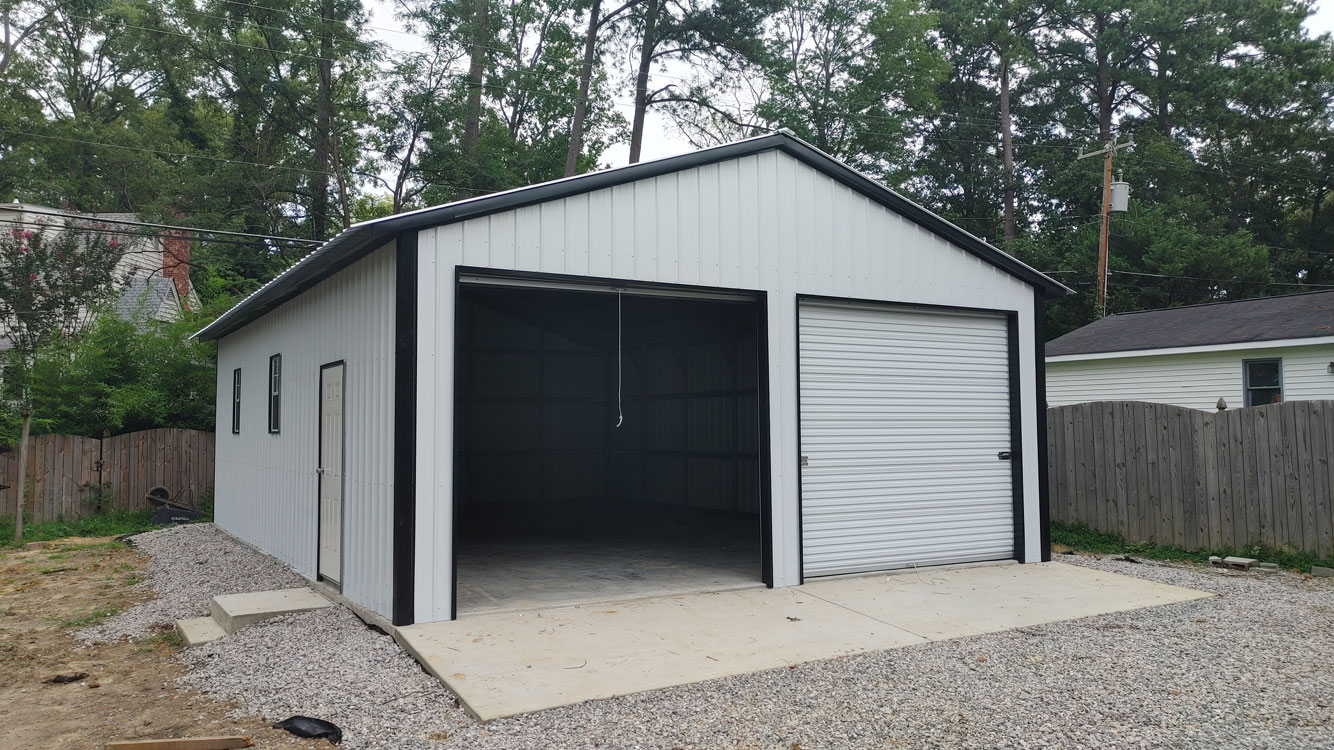 24' wide, 35' long, 10' tall White and Black metal garage with Galvalume vertical metal roof and Bright White vertical metal siding, anchored to Monolithic Concrete Foundation